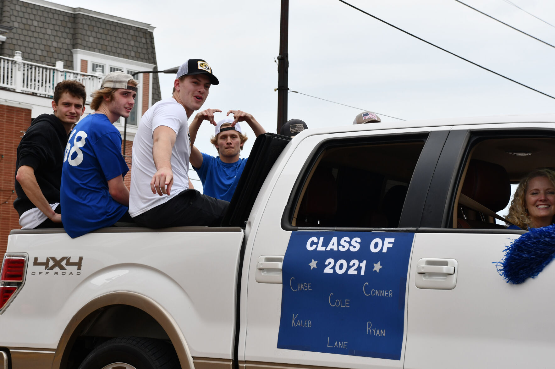 Seniors gather in the bed of a pickup